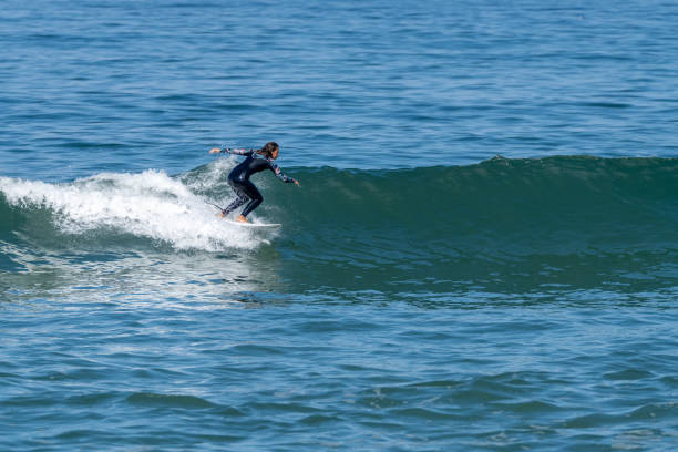 istock Surfer girl riding a wave 1425863619