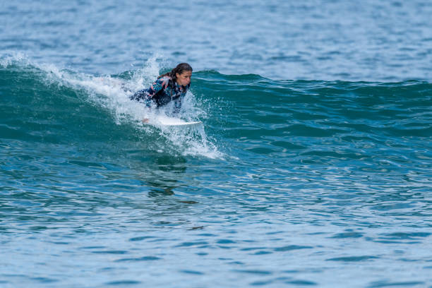 istock Surfer girl riding a wave 1425863639