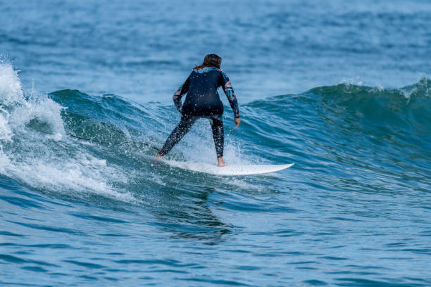 istock Surfer girl riding a wave 1425863661