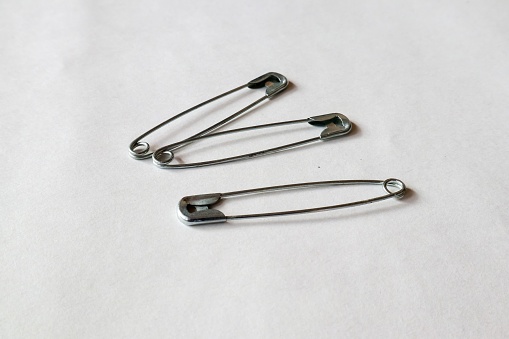 a large safety pin on a white background