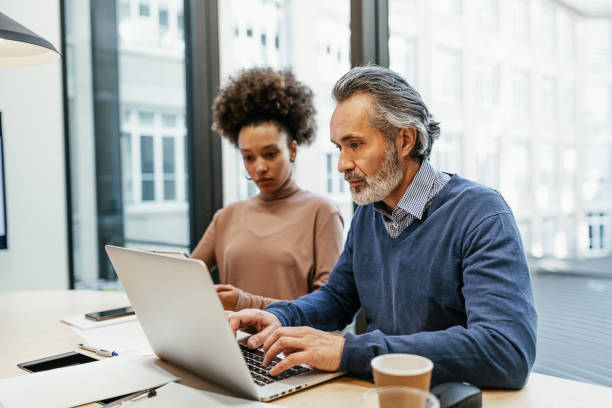 istock Financial experts working together in office and analysing market performance 1425872540