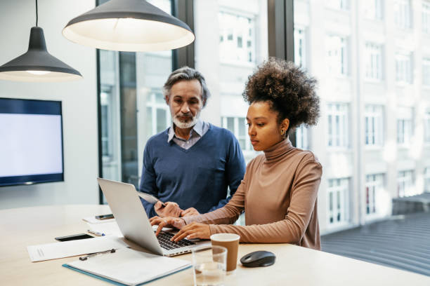 istock Serious multi ethnic employees working together in office and analysing market performance 1425872608