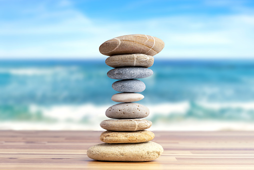 Stacked pebbles to make shape of hourglass as a symbol of time management.