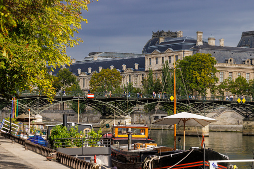 A view of boats on the river Seine taken from Quai de Conti, 75006 Paris, France