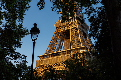 Paris, France, October 4, 2016: A cruise ship sails along the Seine at the Bir-Hakeim Bridge. The bridge has two levels: one for motor vehicles and pedestrians, and a viaduct above, through which the métro trains pass.