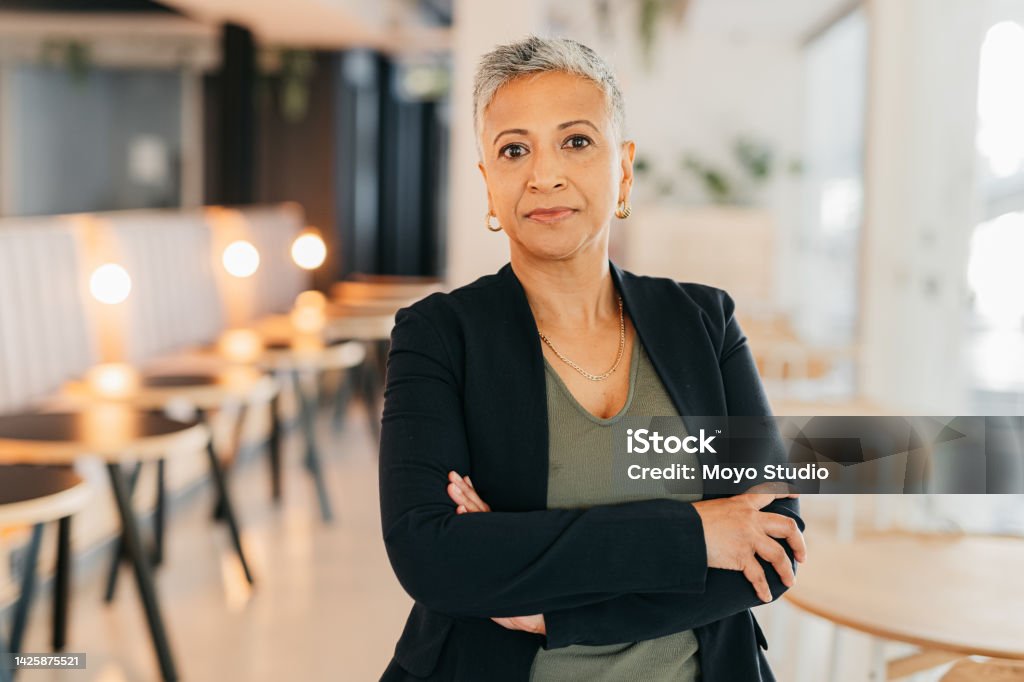 Leadership, success and a proud elderly business woman working in a corporate office, tough and assertive. Mature female power by company CEO satisfied with her career goals and management skills Business Stock Photo