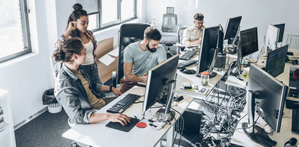 Group of programmers and software developers working on a new project at the office. Group of programmers and software developers working on a new project at the office. web designer stock pictures, royalty-free photos & images