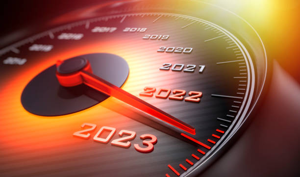 Speedometer 2023 2022 Dark stylish speedometer with orange light and needle moving to the year 2023 speedometer stock pictures, royalty-free photos & images