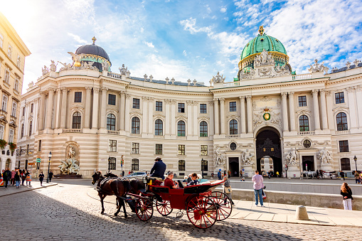 Vienna, Austria - October 2021: Horse carriage at Hofburg palace on St. Michael square (Michaelerplatz)