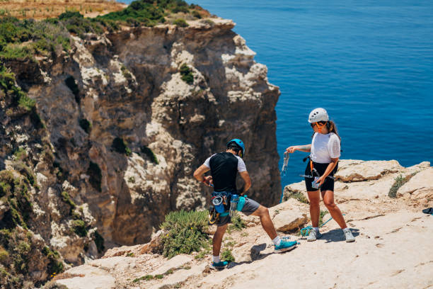 istock Climbers enjoys climbing the mountain and descending from it along the coastal cliffs 1425879762