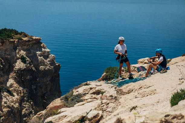 istock Two professional climbers sit on top of a mountain and rest after climbing 1425880067
