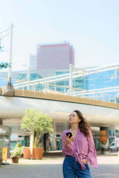 istock Woman text messaging on the phone while walking in The Hague 1425884275