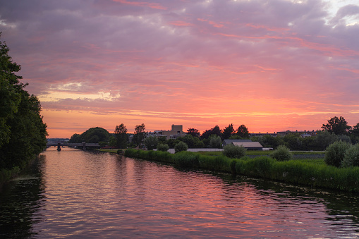 Scenic view of canal in suburbs of Amsterdam at sunset