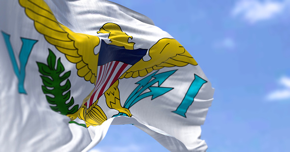 Flag of United States Virgin Islands waving on a clear day. The Virgin Islands of the US, are an unincorporated and organized territory of the US. Seamless loop in slow motion