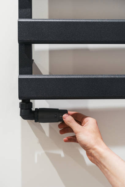 istock Person adjusting temperature on bathroom towel rail 1425889022