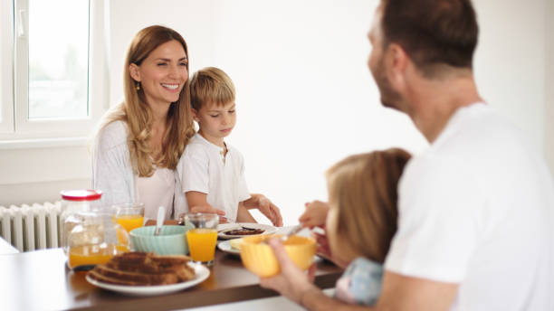 istock Parents with their kids in dining room having breakfast together 1425889075