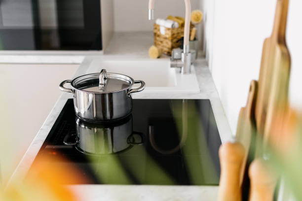 istock Glass ceramic stove with shiny metal pot on top 1425889255