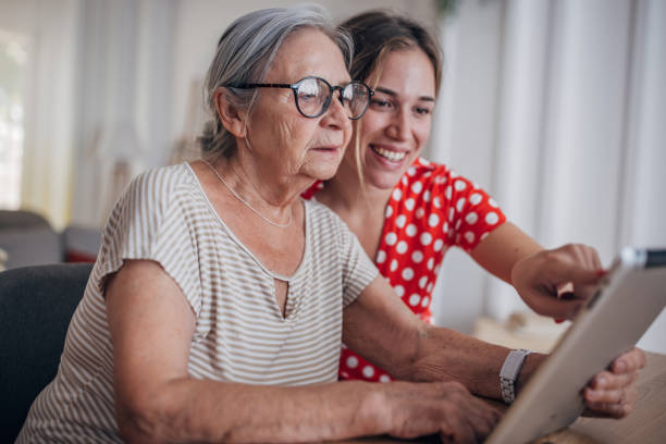 Grandmother and granddaughter use tablet