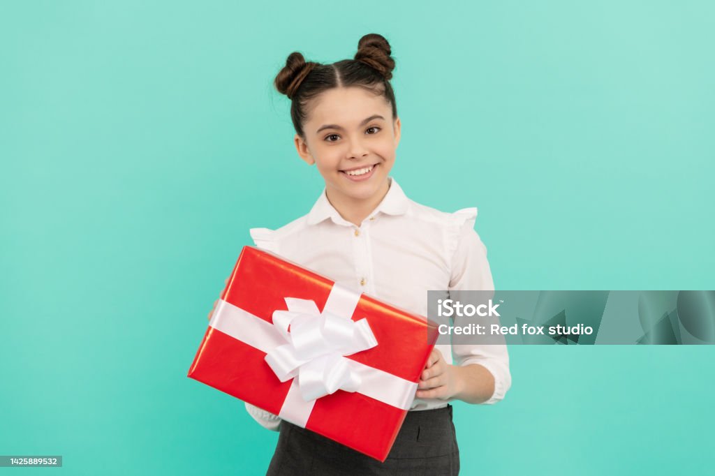 boxing day. present and gifts buy. shopping child with purchase. kid with box. boxing day. present and gifts buy. shopping child with purchase. kid with box. happy birthday holiday. black friday discount. seasonal sales. glad teen girl in school uniform with box. 10-11 Years Stock Photo