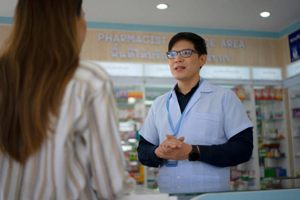 istock Customer is consulting the pharmacist at pharmacy store. 1425889695