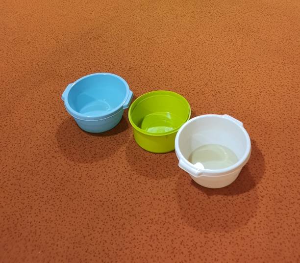 Three plastic washing-up bowls to collect the water from a leaking ceeling in a house. placed on the floor on an orange carpet.