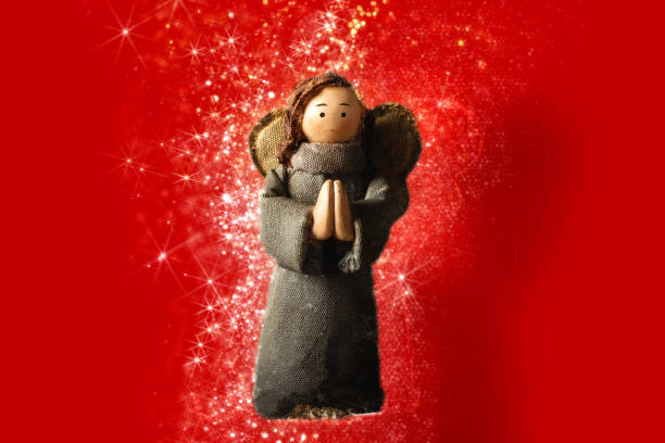 Beautiful young woman making a wish holding star shaped magic wand on black background winter holidays Christmas new year concept