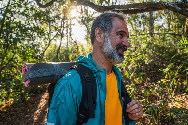 istock Senior man walking through the woods-hiking 1425897338