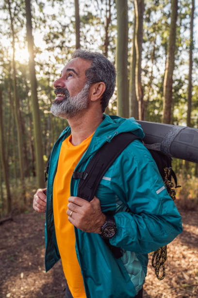 istock Senior man walking through the woods-hiking 1425897813