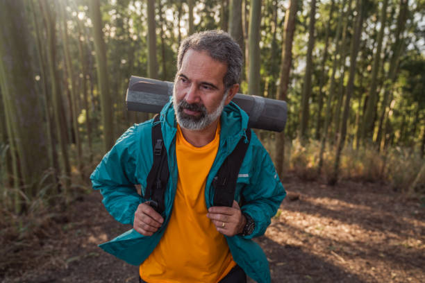istock Senior man walking through the woods-hiking 1425897868
