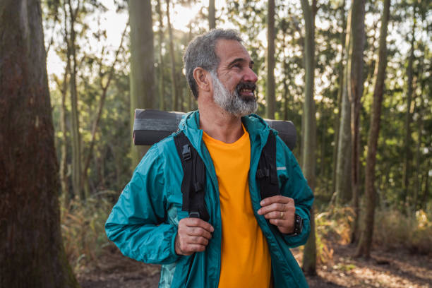 istock Senior man walking through the woods-hiking 1425897924