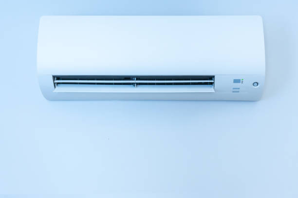istock White wall with hanging air conditioning unit and copy space 1425898374