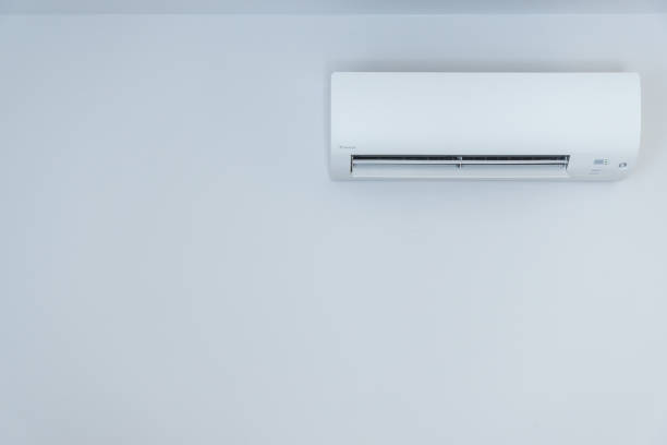 istock White wall with hanging air conditioning unit and copy space 1425898421