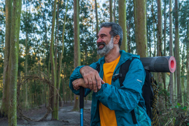 istock Senior man walking through the woods-hiking 1425898744