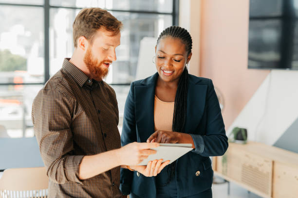 istock Tablet, software and business people with digital, online or website project discussion, communication or meeting. Marketing woman talking of seo social media management analytics report or update 1425898827
