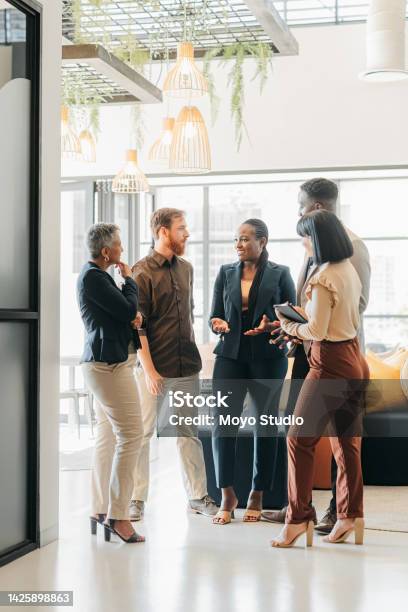 Corporate Team And Leader Talking In The Company Lounge About Creative Collaboration Project Diversity Staff And Professional People Planning Meeting In Office Work Friends Having A Conversation Stock Photo - Download Image Now