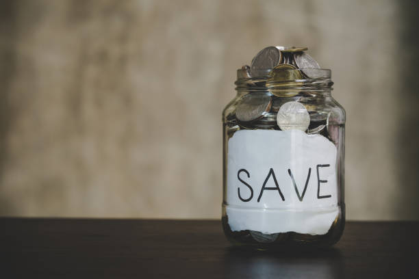 istock coins in a clear glass bottle 1425902201