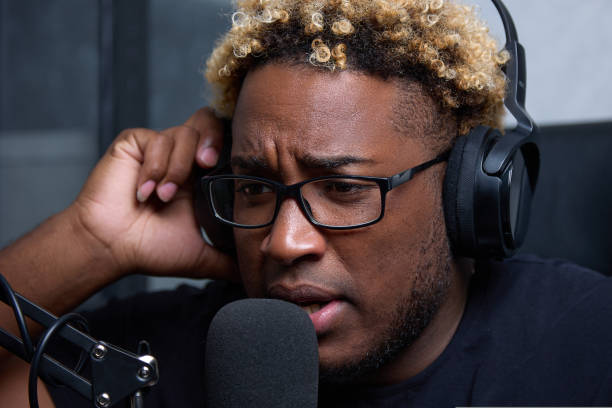istock African blogger records broadcast while looking laptop screen his home desk 1425904758