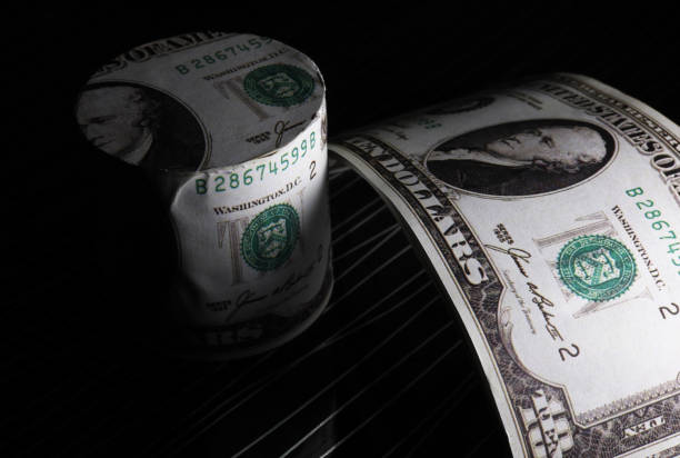 istock rolled paper money dollars  on black background 1425907390