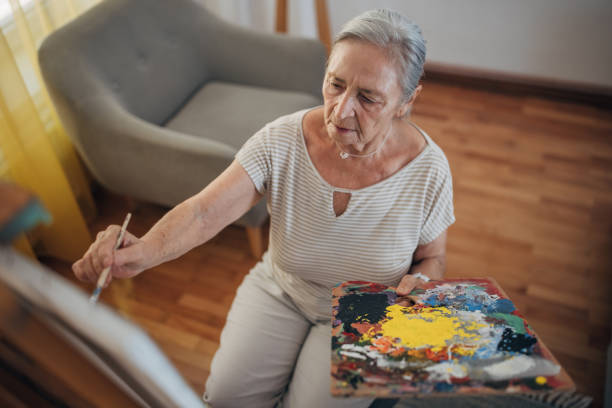 istock Mature female painter enjoying while painting 1425907620