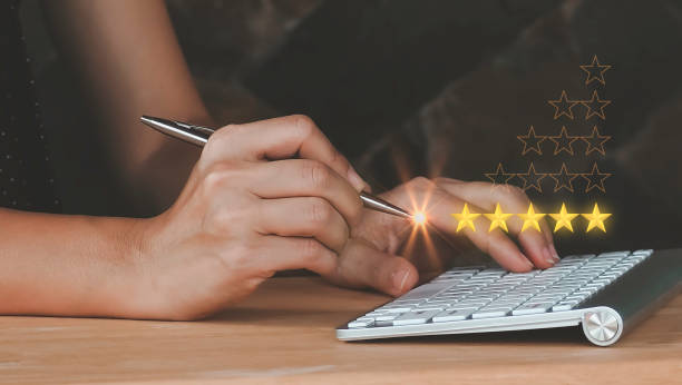 istock closeup women hand using a pen with popup five star icon for feedback review satisfaction service computer Notebook , Customer service experience and business satisfaction survey. 1425913500
