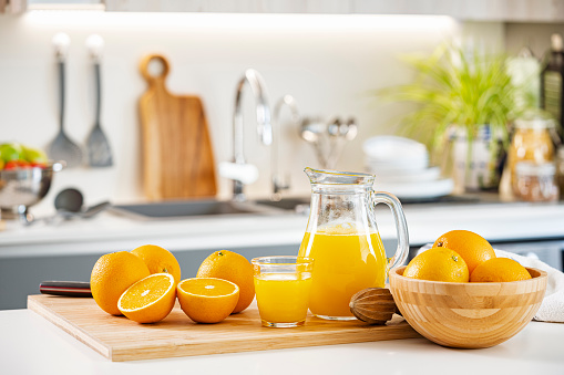 fresh glass of orange juice on rustic table top close up