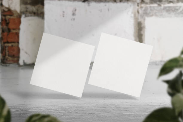 istock Clean minimal square flyer mockup floating on bench cement with plant 1425916706
