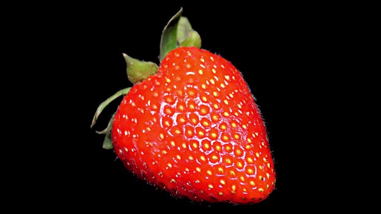 Fresh Strawberry on Black Background close up, detail
