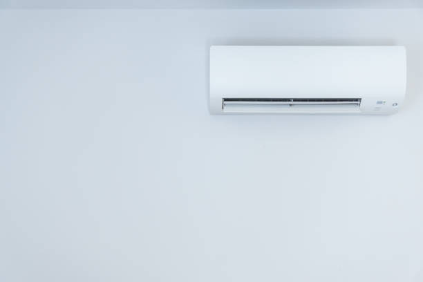 istock White wall with hanging air conditioning unit and copy space 1425925319