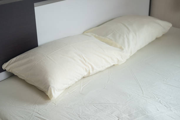 istock Plain light yellow bed and pillow in the bedroom at home 1425927186