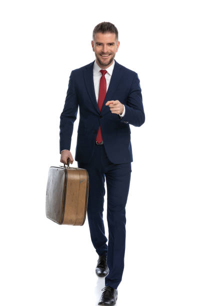 istock businessman walking towards the camera, pointing his finger 1425928017