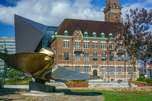 Malmo, Sweden - 20 Sep, 2022: Old meets new modern building with a sculpture in front