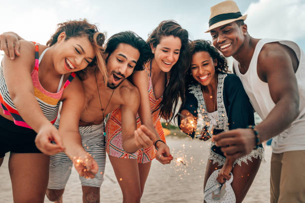 istock friends doing a party at the beach 1425930071