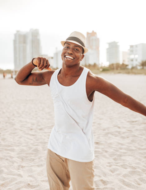 istock happiness afro man dancing on the beach 1425931419