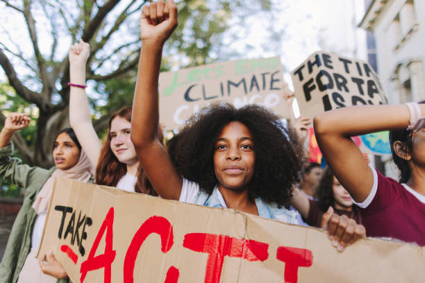 istock Multiethnic teenagers marching against climate change 1425931980